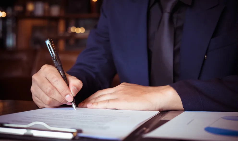 Business person signing document