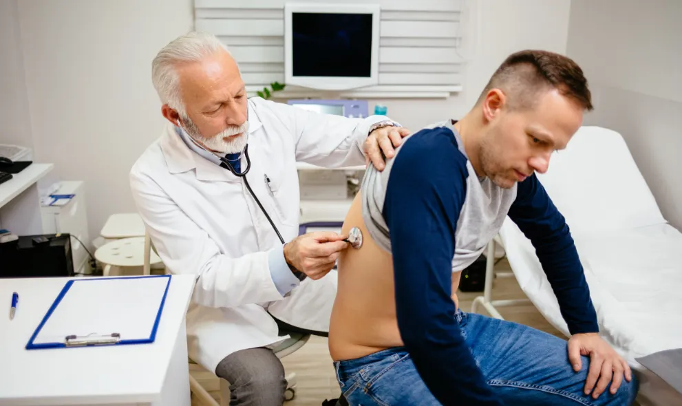 Doctor examining male patient