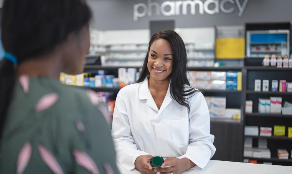 Female pharmacist assists woman in pharmacy