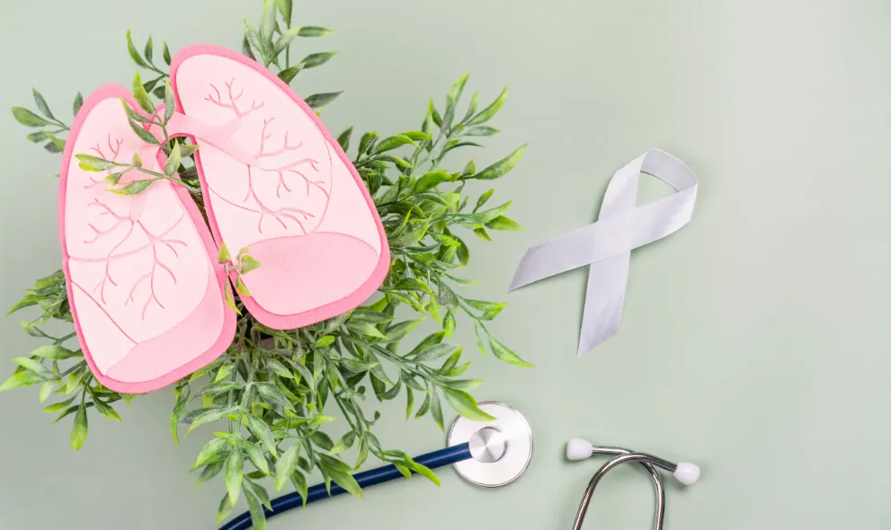 Healthy pink lungs over green foliage white ribbon and stethoscope