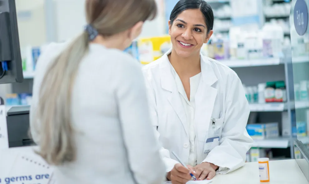 Pharmacist assisting patient with medications