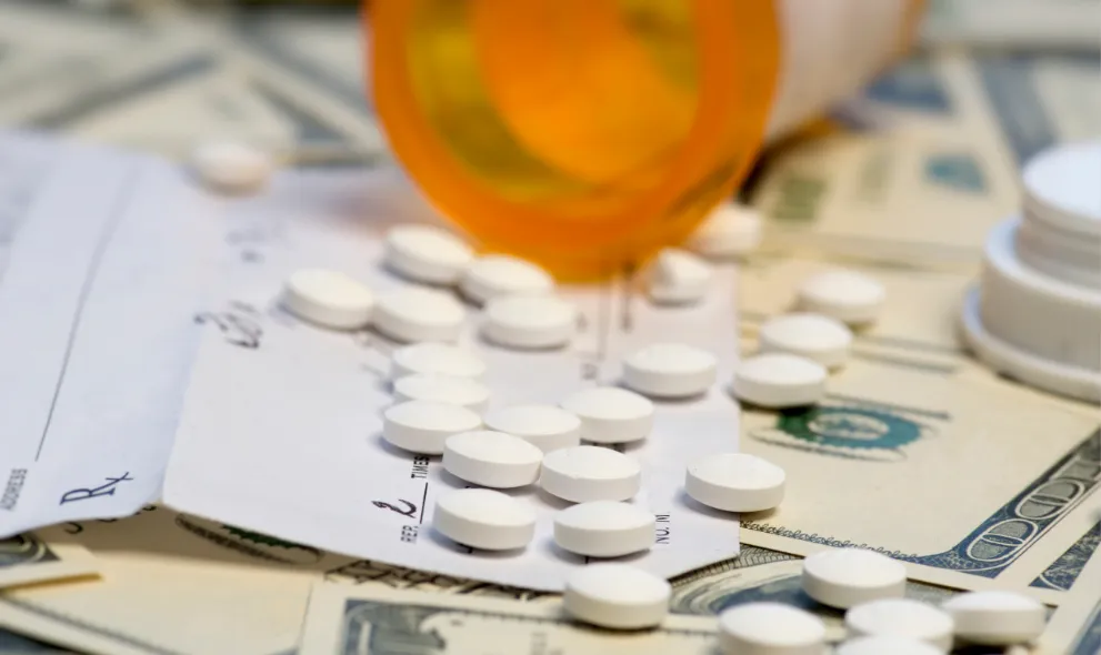 Prescription bottle and pills with money