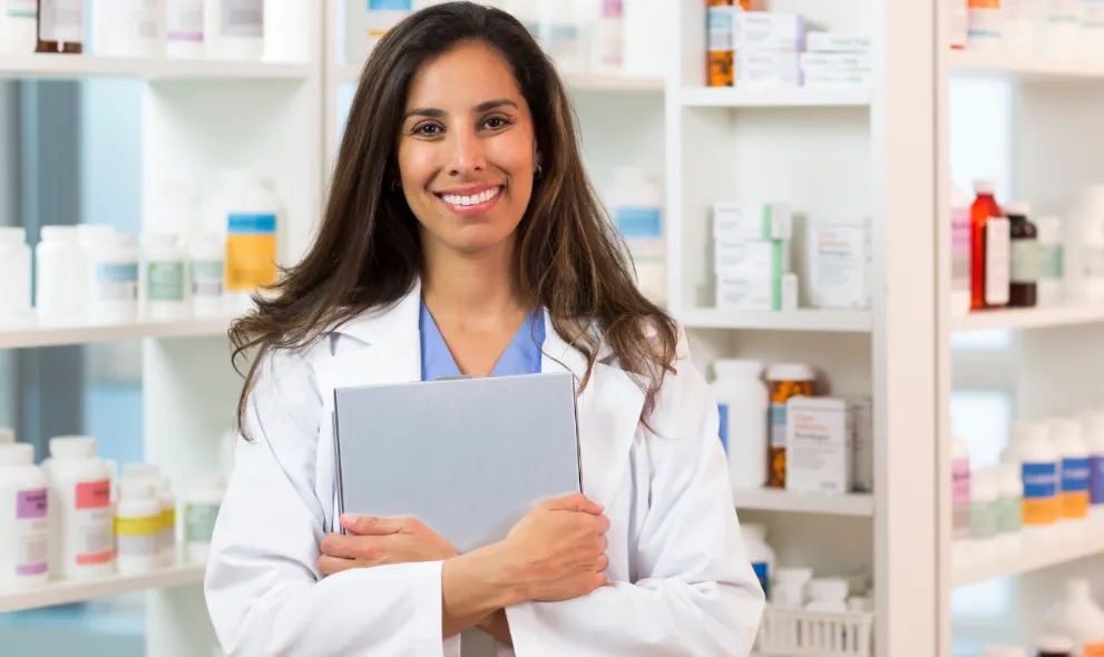 Smiling pharmacist in pharmacy