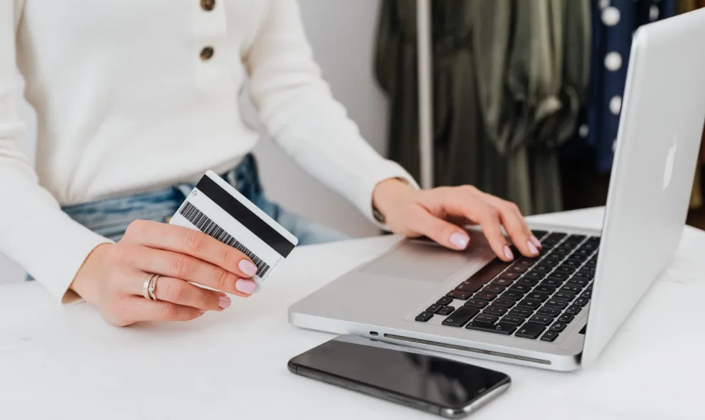 Woman using copay card on laptop