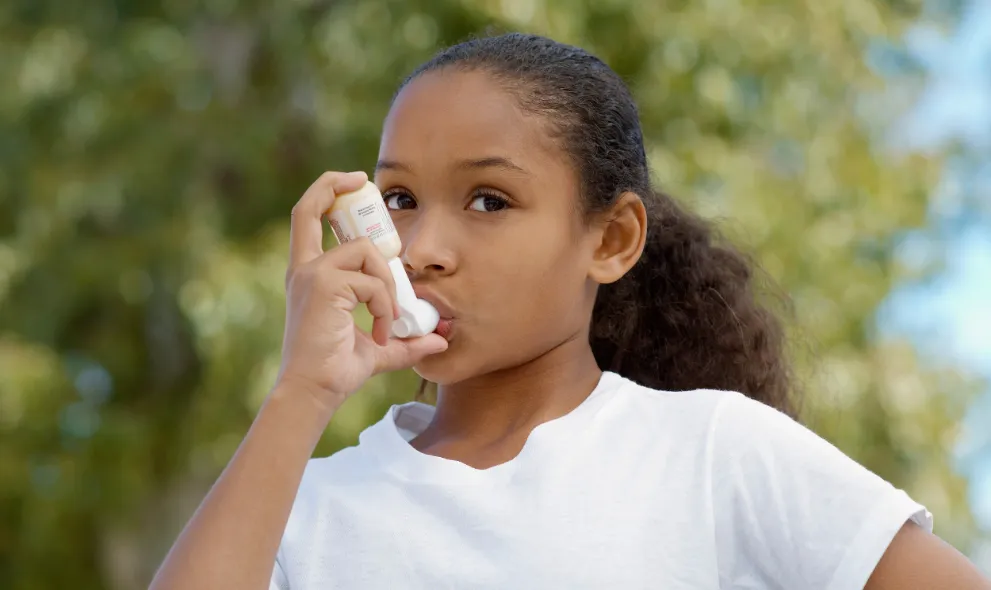 Young girl using an inhaler
