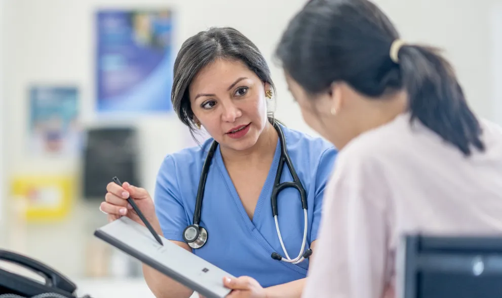 Young woman speaking with her doctor